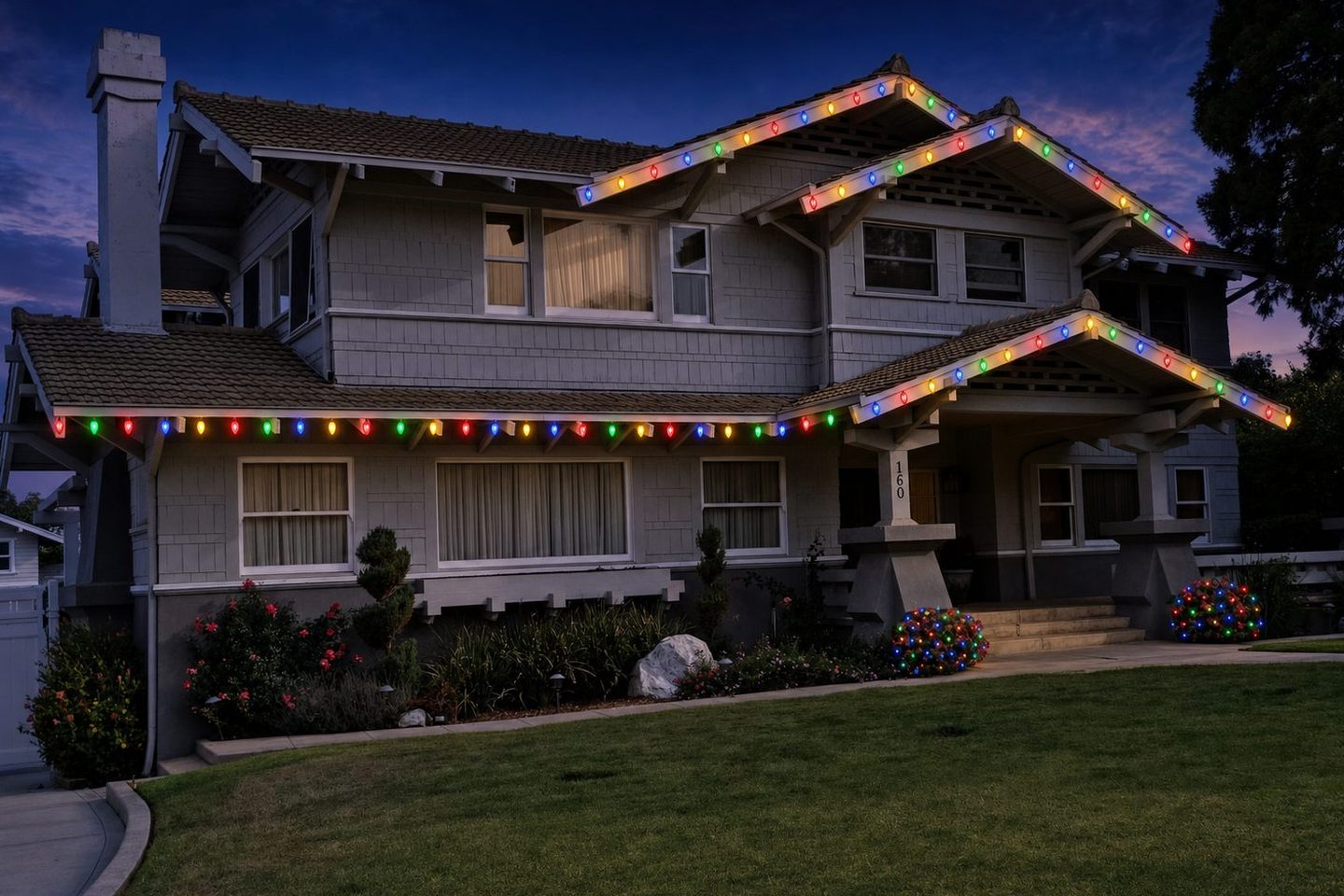 The same craftsman home rendered in the colorful style: multicolor roofline lights and wrapped shrubs